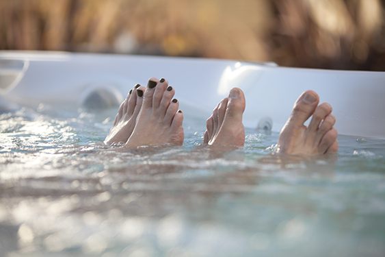 a-couples-toes-appear-out-of-the-water-in-a-close-up-image-2